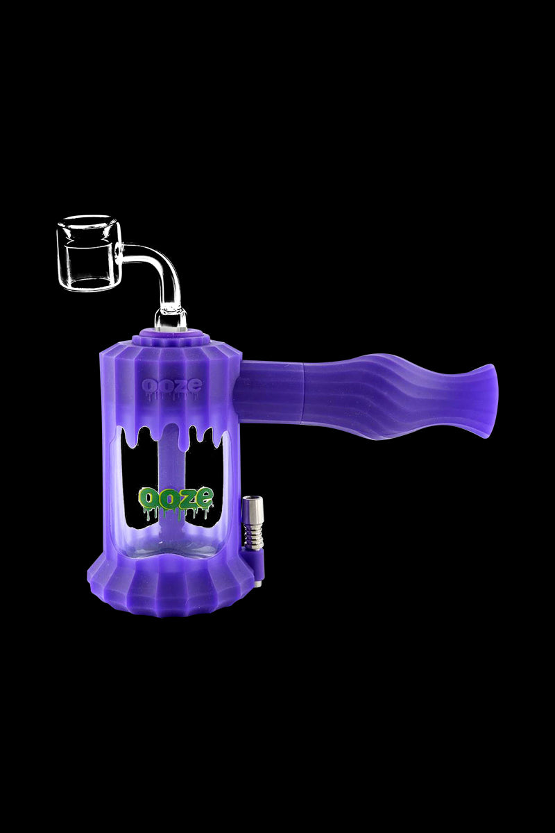 A studio shot of the Clobb 4 in 1 Silicone Pipe, angled slightly to showcase its purple, textured body and simple form.