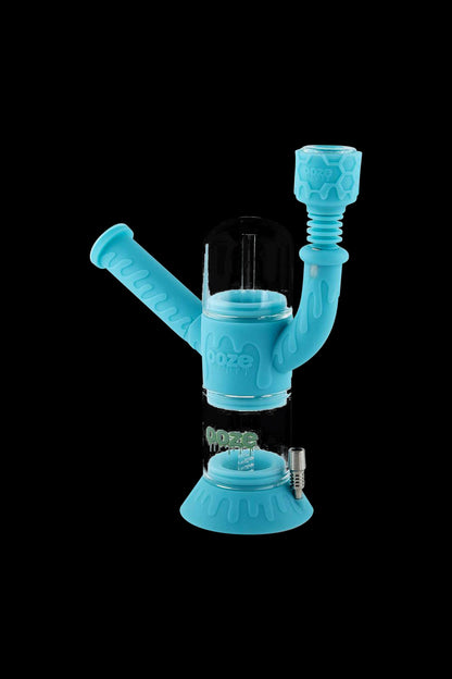 A studio shot of the Ooze "Cranium" Silicone 4-in-1 Glass Water Pipe, displaying its unique, skull-shaped design and clear glass construction.