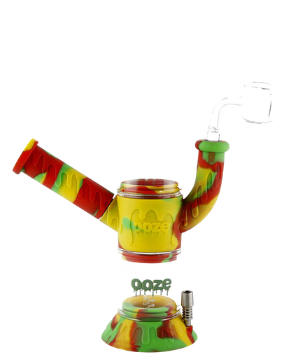 Front view of the Ooze "Cranium" Silicone 4-in-1 Glass Water Pipe, showcasing a colorful, patterned silicone grip on a clear glass body.