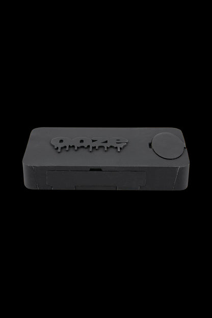 A close-up, angled view of the Ooze Slugger Dabbin Dugout, showcasing its sleek, dark design and compact size.