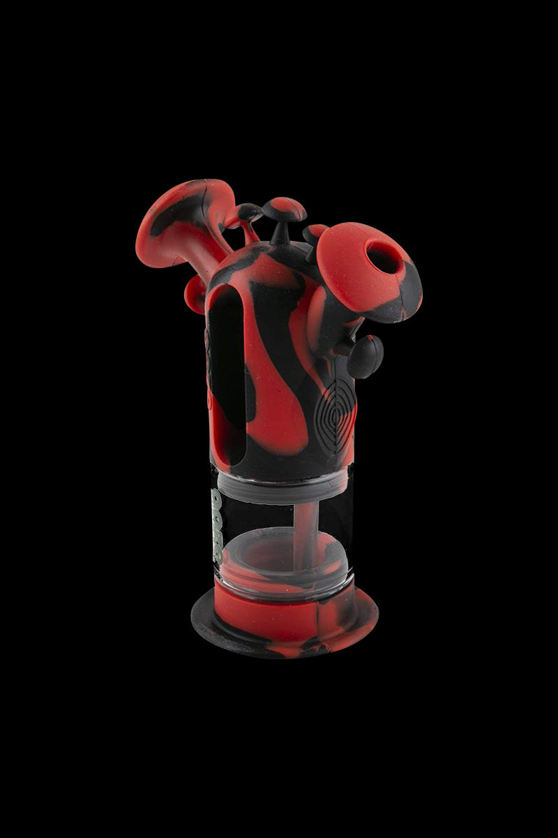 A studio shot of the Ooze "Trip" Silicone Bubbler, showcasing its compact size and colorful, textured design against a black backdrop.