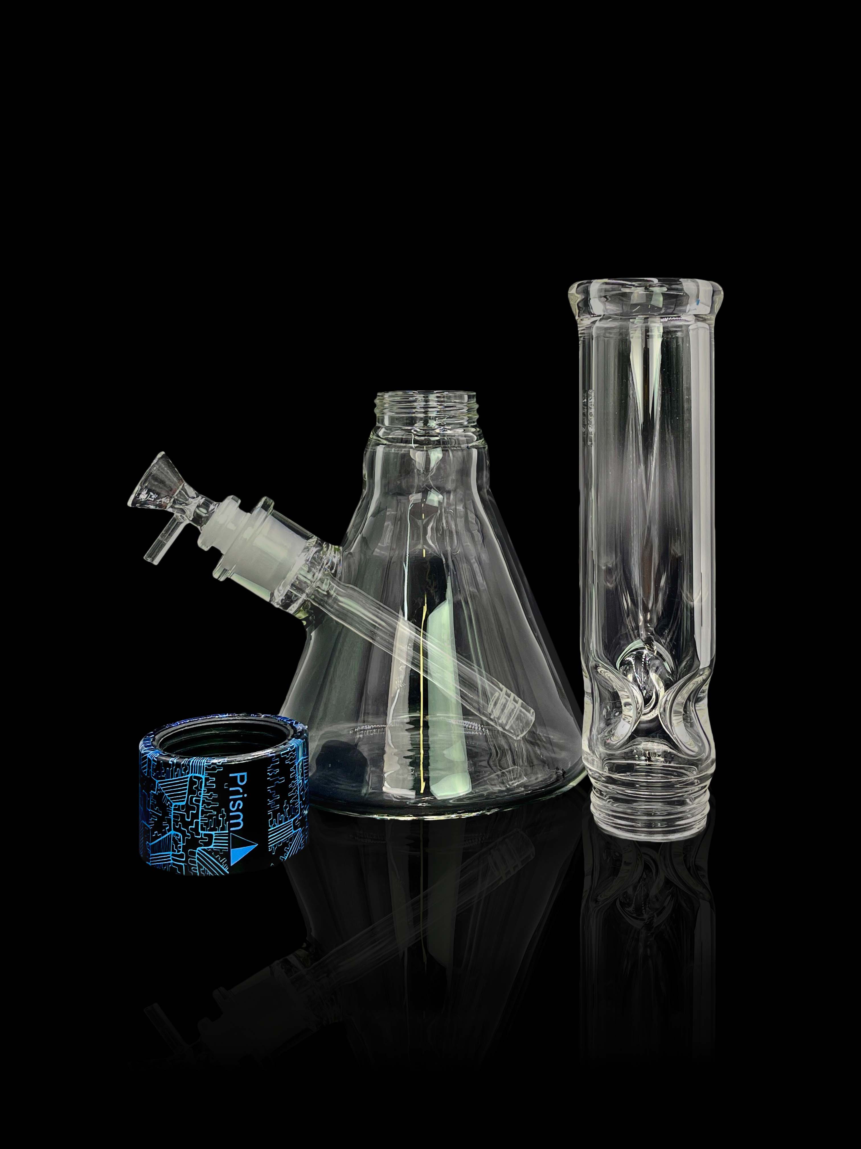 A studio shot displays the Prism Water Pipes Starter Kit, a clear glass water pipe viewed from a low angle.