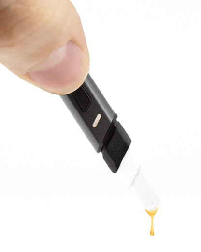 Close-up view of the Puffco Hot Knife being held, showcasing its black, slender design and metallic accent.