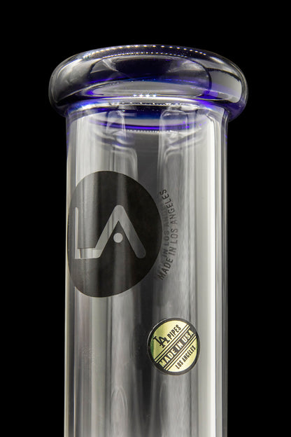 A clear glass water pipe with blue accents, featuring a black "LA" logo and "LA PIPES MADE IN USA LOS ANGELES" text.