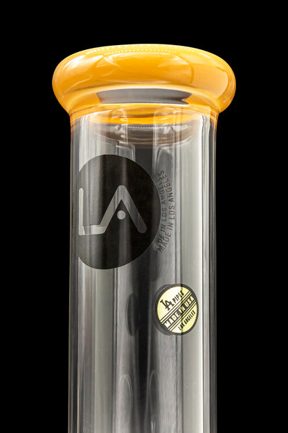 A sleek, black glass water pipe with a rounded amber mouthpiece, branded with a stylized "LA" logo and "Made in USA".