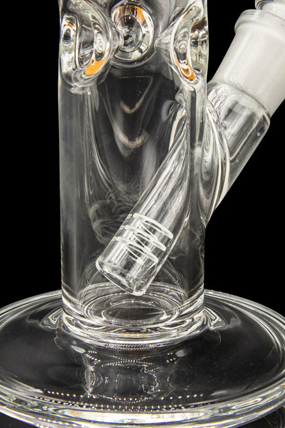 Clear glass water pipe (bong) with intricate swirling patterns and a diffused downstem, isolated on a black background.