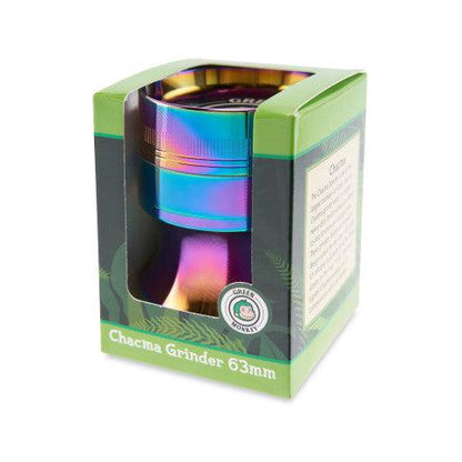 Three-quarter view of a rainbow-finish Green Monkey Chacma Grinder with Ashtray in its green retail box, lit from the top against a white background