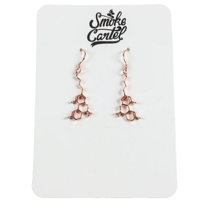 A detailed close-up of the Smoke Cartel THC Molecule Earrings, showcasing their intricate, scientific design against a plain white background.