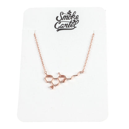 Close-up of the Smoke Cartel THC Molecule Necklace, a delicate silver pendant shaped like a molecular structure.