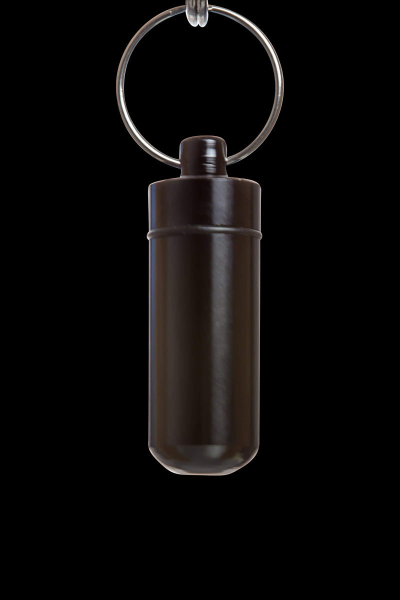 Front view of the Discrete Key Chain Stash Jar, a sleek, silver container suspended by a circular key chain against a dark backdrop.