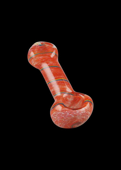 A studio shot of the Simple Colorful Spoon Pipe - Balloon Strings, displaying its curved shape and vibrant coloring against a plain black backdrop.