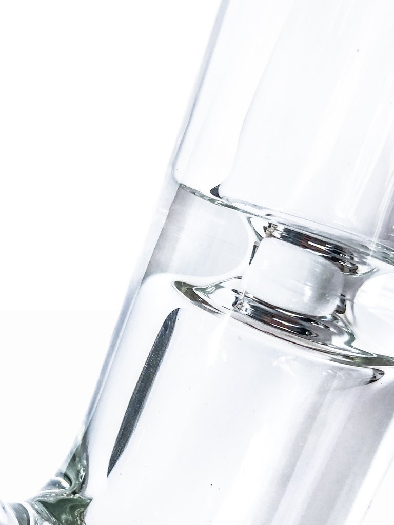 Close-up view of the Tank Glass Straight Tube Bong, showcasing its clear glass construction and simple cylindrical shape.