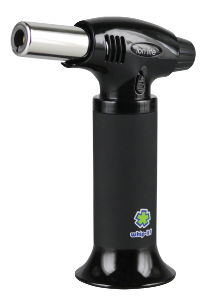 A close-up view of the whip-it! Ion Lite Torch Lighter, showing its black body and metallic nozzle angled slightly upwards.