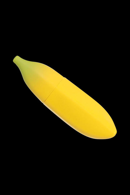 Diagonal close-up of the Metal Hand Pipe with Silicone Banana Skin on a black background, showing its yellow banana-shaped silicone body and green-tinted tip.
