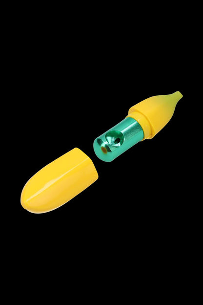 Close-up on a disassembled Metal Hand Pipe with Silicone Banana Skin showing a yellow silicone peel and a green metal chamber on black.
