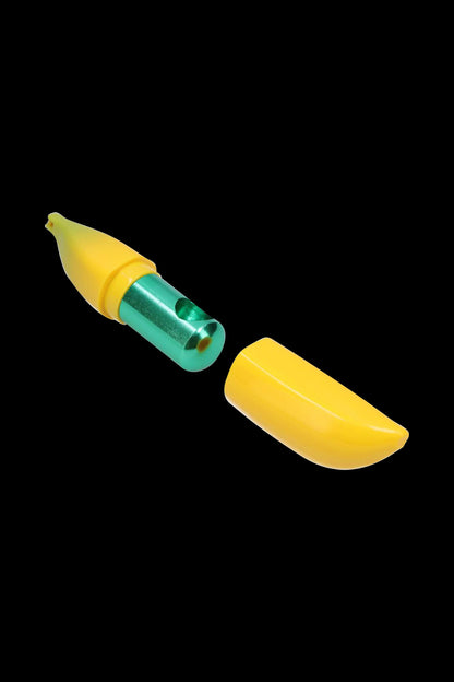 Angled close-up of a disassembled Metal Hand Pipe with Silicone Banana Skin showing a green metal inner tube and bright yellow silicone banana-shaped sleeve on a black background